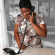Adult African American female using Voice Carry Overs service.